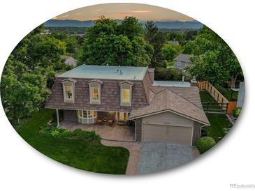Charming home with manicured lawn, lovely landscaping, and attractive brick exterior at 6359 S Locust Way, Centennial, CO 80111