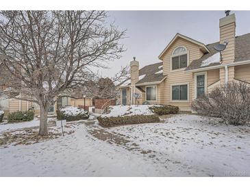 Attractive exterior of a townhouse with a landscaped yard and walkway at 2121 S Troy Way, Aurora, CO 80014