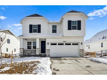 Beautiful two-story home featuring a two car garage, porch and well-manicured lawn at 39720 Congress Ln, Elizabeth, CO 80107