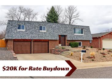 Charming two-story brick home with a two-car garage and a well-maintained front yard at 10679 Union Way, Broomfield, CO 80021