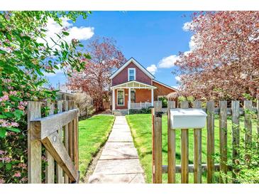Charming brick home with a well-maintained front yard and a wooden fence with an inviting walkway leading to the front porch at 3513 Quitman St, Denver, CO 80212