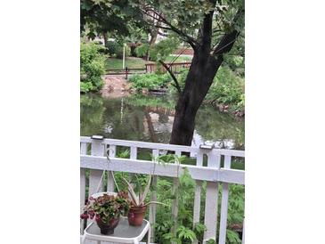 Relaxing view of the community pond, surrounded by lush landscaping and calming water features at 2840 S Kenton Ct, Aurora, CO 80014