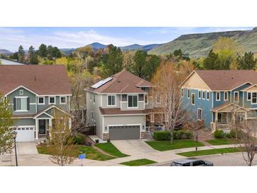 Two-story home with well-manicured lawn and mountain views, including solar panels at 15960 W 62Nd Dr, Arvada, CO 80403