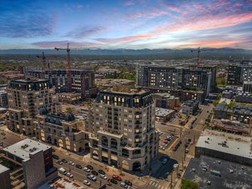 Scenic aerial view of luxurious high-rise buildings at sunset, showcasing the surrounding cityscape and mountain backdrop at 975 N Lincoln St # 3H, Denver, CO 80203