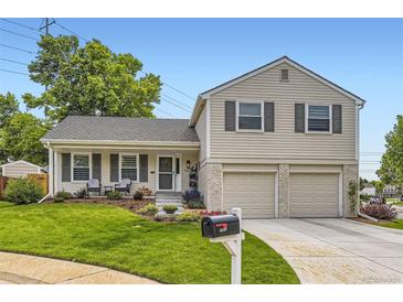 Charming two-story home with a well-manicured lawn, complemented by a two-car garage and tasteful landscaping at 7465 S Ivy Way, Centennial, CO 80112