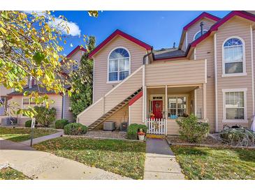 Inviting condo with a quaint red door and stairs leading to an upper-level entrance at 8371 S Upham Way # 208, Littleton, CO 80128