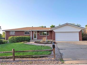 Brick ranch home with attached garage and landscaped yard at 13390 W 8Th Ave, Lakewood, CO 80401