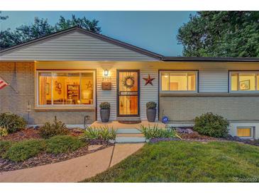 Charming ranch home with landscaped lawn and inviting front porch at 3701 W Greenwood Pl, Denver, CO 80236