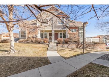Charming townhome with stone accents, a well-manicured lawn, and a cozy front porch at 12814 Jasmine St # C, Thornton, CO 80602