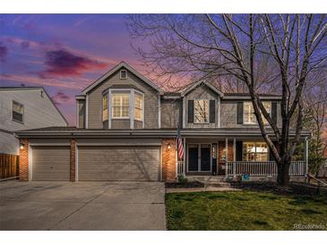 Charming two-story home with a three car garage and a welcoming front porch at 13340 Saint Paul St, Thornton, CO 80241