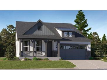 Charming craftsman style home with gray siding, and a two-car garage at 565 Twilight St, Erie, CO 80516