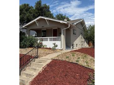 Charming bungalow with covered porch and red mulch landscaping at 4804 N Raleigh St, Denver, CO 80212