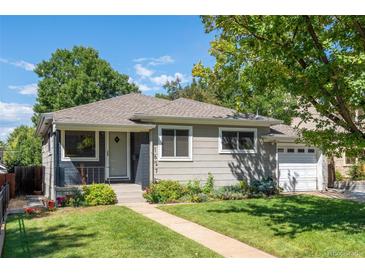 Charming single-story home featuring a well-maintained lawn, garden beds, and a welcoming front porch at 1627 S Saint Paul St, Denver, CO 80210