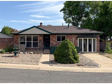 Charming brick home with a well-maintained front yard and mature landscaping at 10440 Gilpin St, Northglenn, CO 80233