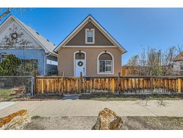 Charming home featuring a cozy exterior with a well-maintained yard and quaint wooden fence at 4648 Josephine St, Denver, CO 80216