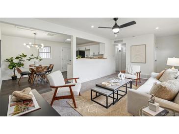 Bright living room features modern furnishings, neutral decor, and an open layout that flows into the kitchen at 1330 Oak Pl, Thornton, CO 80229
