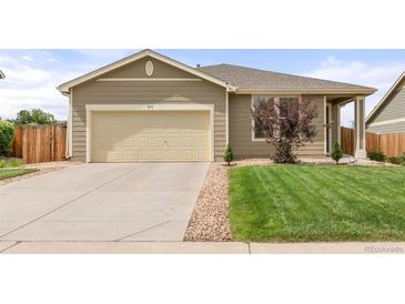 Inviting single-story home featuring a well-kept lawn, concrete driveway, and attached two-car garage at 848 Sagebrush Dr, Brighton, CO 80603