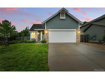 Charming home with a well-manicured lawn, a two-car garage, and a welcoming facade at 1280 W 134Th Pl, Westminster, CO 80234