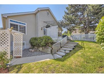 Well-maintained backyard featuring a patio, lush lawn, and landscaping, offering a serene outdoor space at 2265 S Depew St, Denver, CO 80227