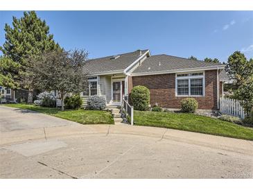 Charming single-story home with brick accents, manicured lawn, mature trees, and inviting entrance at 2265 S Depew St, Denver, CO 80227