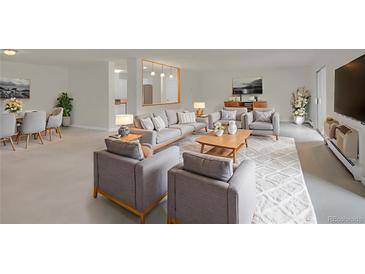 Bright living room with modern gray sofas, wood accents, and stylish decor offers comfortable seating and living space at 3144 S Wheeling Way # 206, Aurora, CO 80014