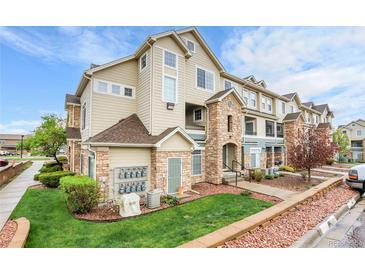 Attractive exterior view of a multi-story condo building featuring stone accents and well-maintained landscaping at 457 Black Feather Loop # 703, Castle Rock, CO 80104