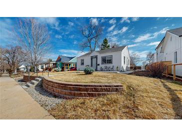 Charming home featuring a well-maintained lawn and inviting curb appeal on a beautiful day at 4154 Depew St, Denver, CO 80212