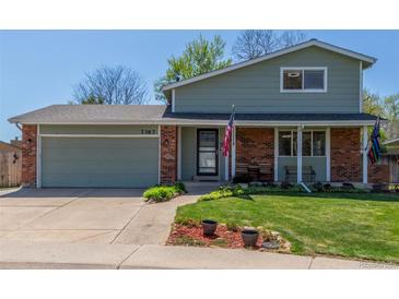 Charming two-story home with brick accents, a well-maintained lawn and a two car garage at 7367 Coors St, Arvada, CO 80005