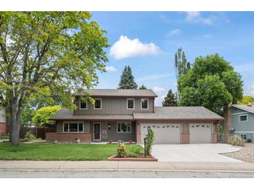 Charming two-story home with a manicured lawn, complemented by a three car garage and classic exterior at 7409 Mount Meeker Rd, Longmont, CO 80503