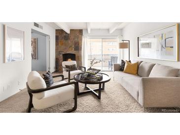 Inviting living room featuring a cozy fireplace, neutral tones, and bright natural light at 1365 Columbine St # 301, Denver, CO 80206