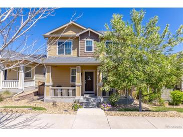 Charming two-story home with a welcoming front porch and well-maintained landscaping and a lovely 'hello' wreath at 3793 Cadence Dr, Castle Rock, CO 80109