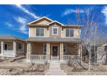 Charming two-story home with a welcoming front porch and well-maintained landscaping at 3793 Cadence Dr, Castle Rock, CO 80109