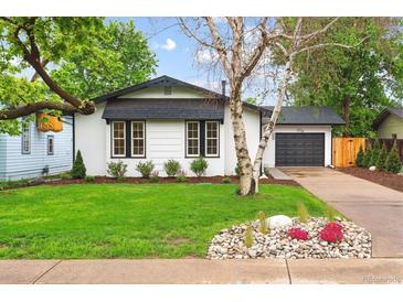 Charming home featuring a well-manicured lawn and rock garden at 5553 S Datura St, Littleton, CO 80120