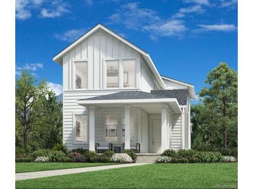 Inviting two-story home featuring white siding, a covered porch, and professionally landscaped front yard at 918 Promenade Dr, Superior, CO 80027