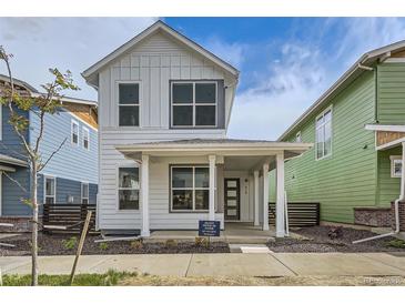 Charming two-story home with a covered front porch, white siding, and modern design at 918 Promenade Dr, Superior, CO 80027