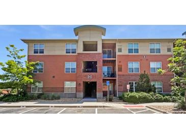 Attractive brick apartment building with mature trees and manicured landscaping at 4100 Albion St # 523, Denver, CO 80216