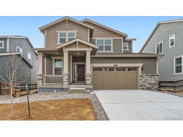 Two-story home featuring a two-car garage, covered porch, and neutral color scheme at 5578 Inland Ave, Firestone, CO 80504