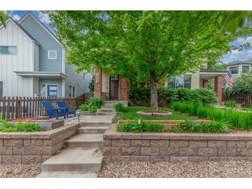 Charming home featuring a landscaped front yard with stone accents and a mature tree for added curb appeal at 3322 W 26Th Ave, Denver, CO 80211