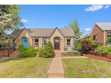 Charming brick home with a well-manicured lawn and inviting front porch seating at 2435 N Irving St, Denver, CO 80211