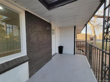 A covered front porch area leads up to the front door of this lovely home at 6851 Krameria St, Commerce City, CO 80022