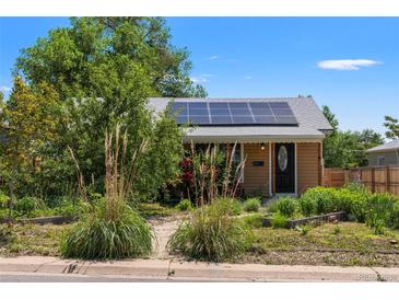 Charming home featuring solar panels, a well-manicured yard and walkway at 46 S Perry St, Denver, CO 80219