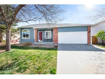 Charming single Gathering home featuring blue siding, a two-car garage, and a well-manicured front lawn at 1444 S Richfield Way, Aurora, CO 80017