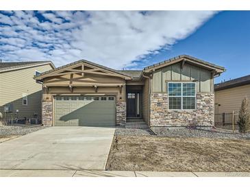 Beautiful single-story home featuring stone accents, a two-car garage, and manicured landscaping at 2978 Newfound Lake Rd, Berthoud, CO 80513