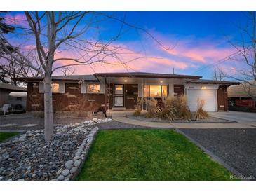 Brick ranch home with landscaped yard and mature trees at 8089 Greenwood Blvd, Denver, CO 80221