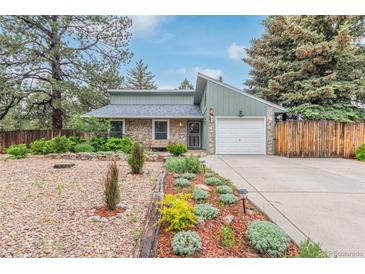Charming single-Gathering home with a stone exterior, attached garage, and well-maintained front yard at 881 S Pearl St, Elizabeth, CO 80107