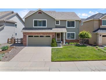 Charming two-story home with a well-manicured lawn, brick accents and an attached two car garage at 42 Blue Sage, Littleton, CO 80127