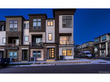 Contemporary townhome showcases a stylish exterior, private balconies, well-kept landscaping, and street parking at 375 Marshall Rd, Superior, CO 80027