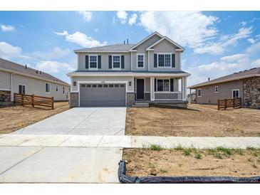 Charming two-story home with a covered porch, two car garage, and neutral color scheme at 1376 Lumber Ridge N Cir, Erie, CO 80516