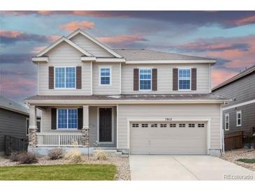Lovely two-story house featuring a welcoming porch and a spacious two-car garage at 7812 Blue Water Ln, Castle Rock, CO 80108