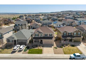 Charming neighborhood street view showcasing the exteriors of well-maintained homes with front lawns at 7812 Blue Water Ln, Castle Rock, CO 80108